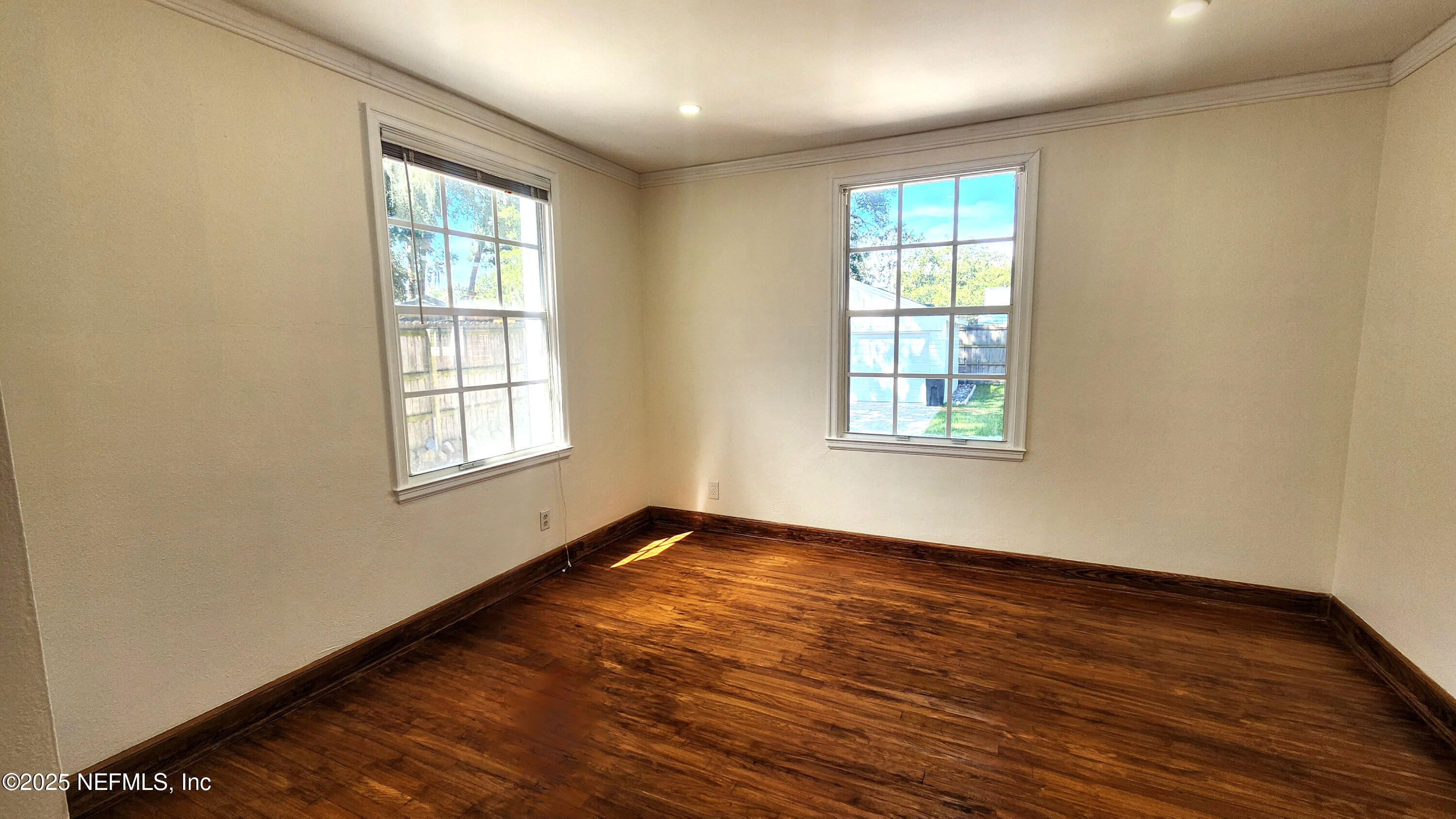 1418 Nicholson Road Jacksonville, FL 32207 - Photo 21 of 35 an empty room with wooden floor and windows