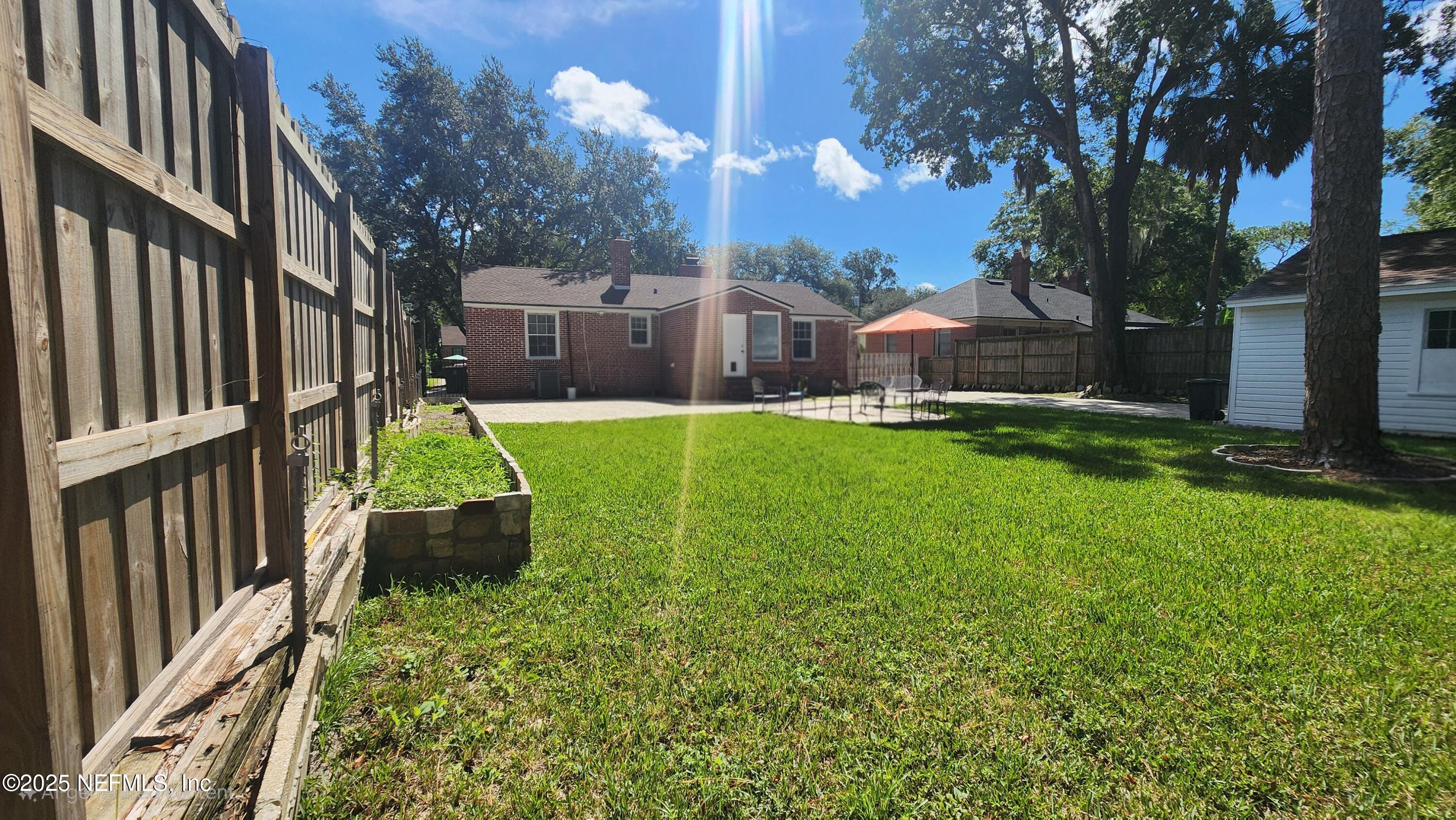 1418 Nicholson Road Jacksonville, FL 32207 - Photo 30 of 35 a view of a house with a big yard and a large tree