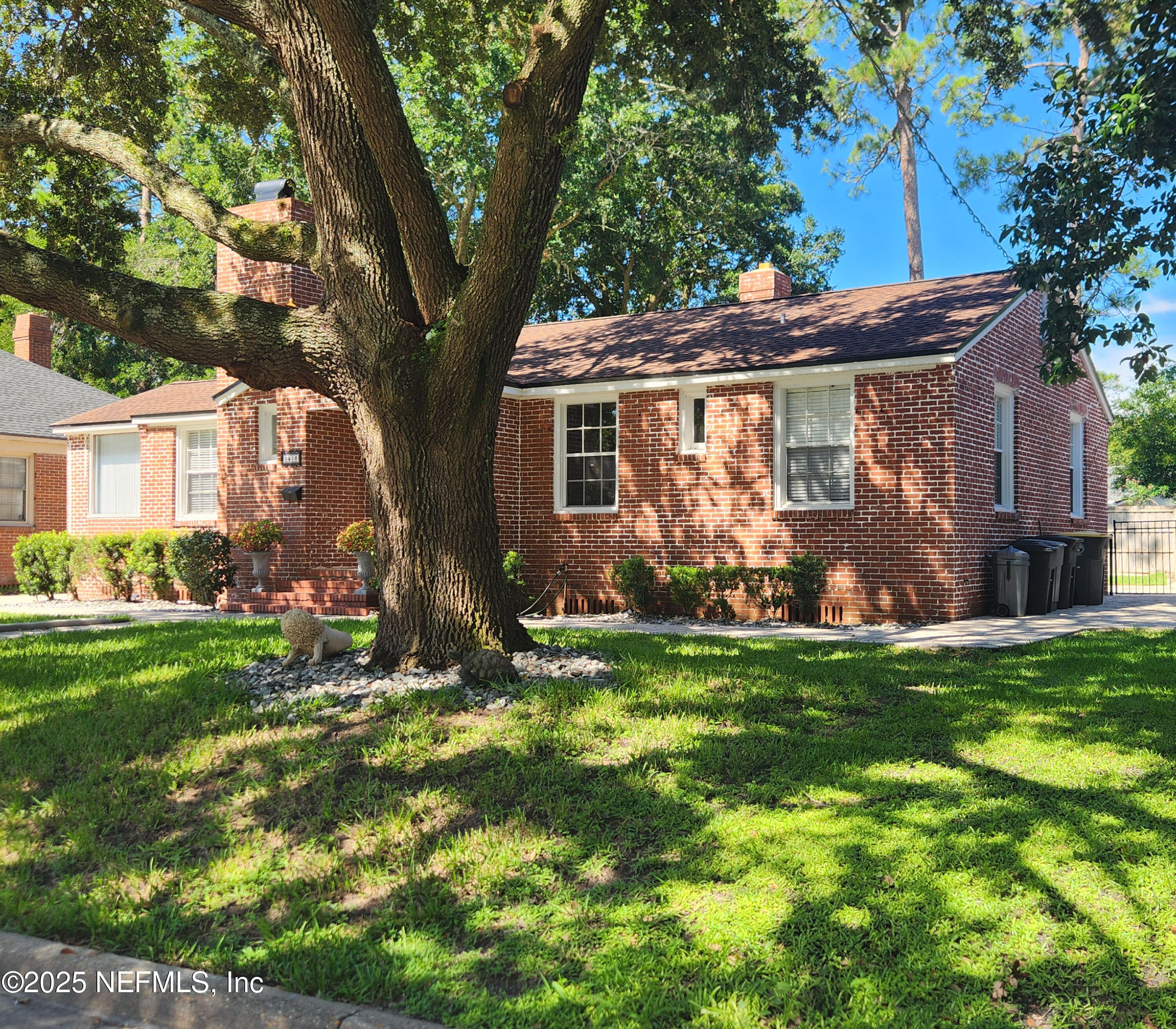 1418 Nicholson Road Jacksonville, FL 32207 - Photo 3 of 35 a view of a yard in front of a house with large trees
