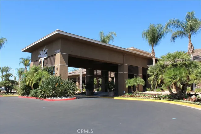 a view of a house with small yard and plants
