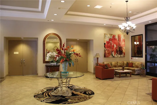 a living room with furniture and a chandelier