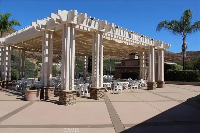 a view of spacious bedroom with a large window and plants
