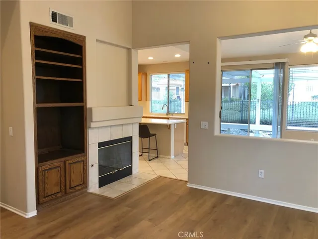 a view of a livingroom with a fireplace and window