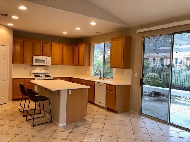 a kitchen with a sink a stove cabinets and counter space