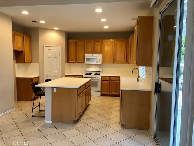 a kitchen with kitchen island cabinets and refrigerator