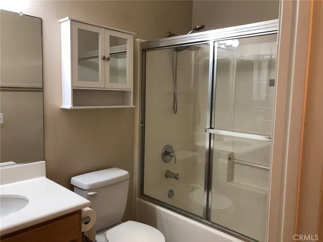 a bathroom with a shower and toilet