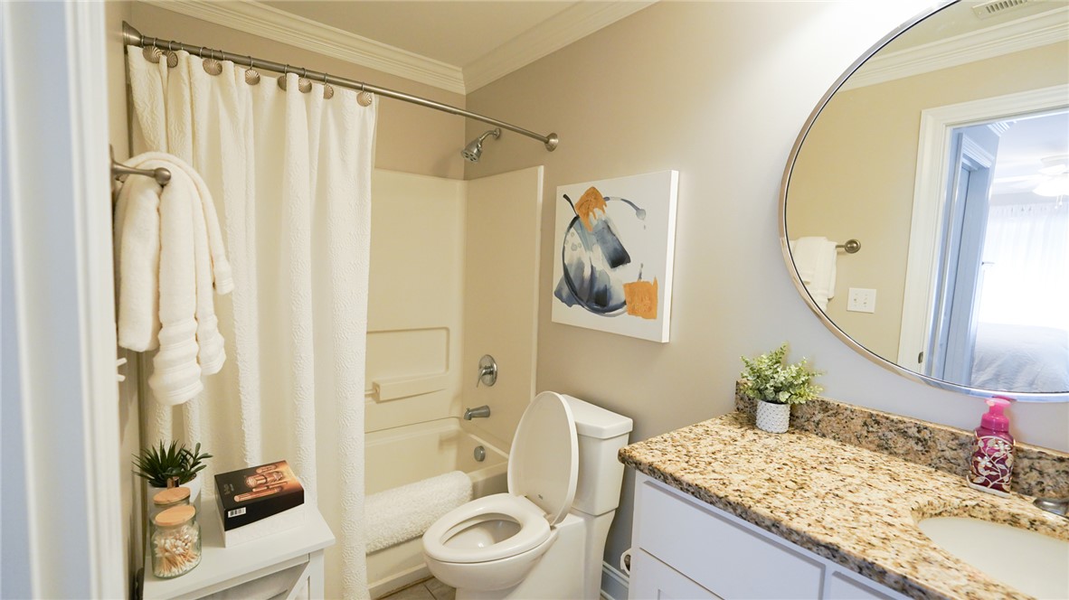 303 Lookover Drive Anderson, SC 29621 - Photo 33 of 46 This bathroom features a functional tub and shower combination, complemented by a granite counter and tile flooring.