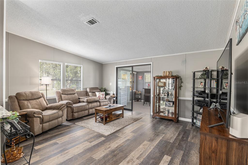 1727 Hilton Head Boulevard Lady Lake, FL 32159 - Photo 11 of 39 a living room with furniture and a flat screen tv