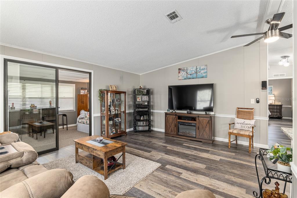 1727 Hilton Head Boulevard Lady Lake, FL 32159 - Photo 15 of 39 a living room with furniture and a flat screen tv