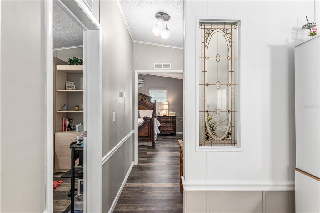 1727 Hilton Head Boulevard Lady Lake, FL 32159 - Photo 16 of 39 a view of a hallway with wooden floor and windows