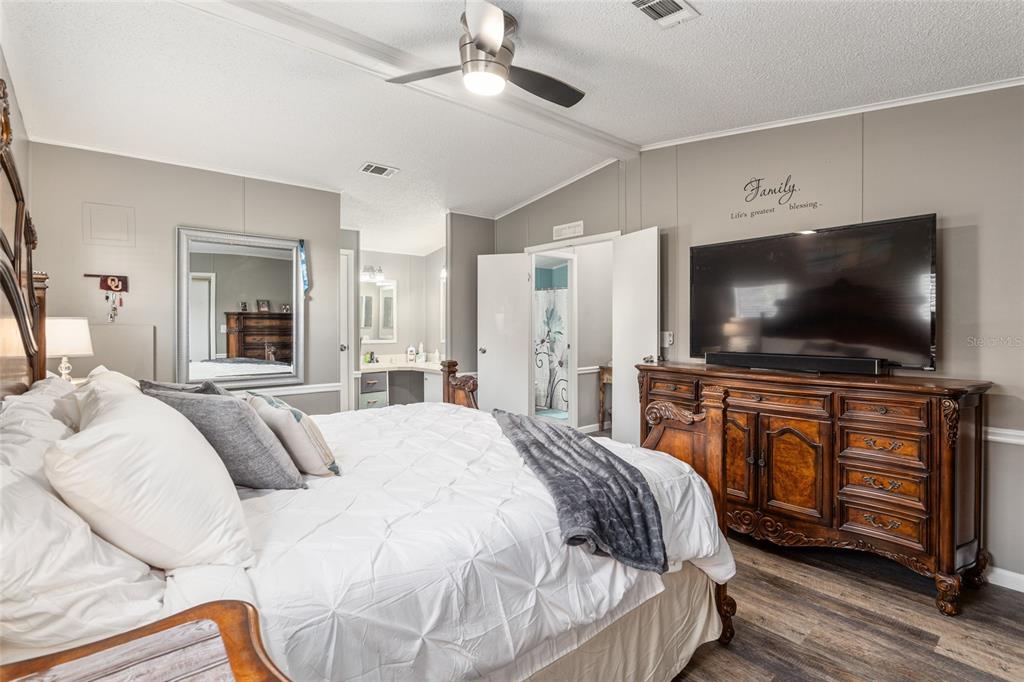 1727 Hilton Head Boulevard Lady Lake, FL 32159 - Photo 18 of 39 a bedroom with a flat screen television and a bed