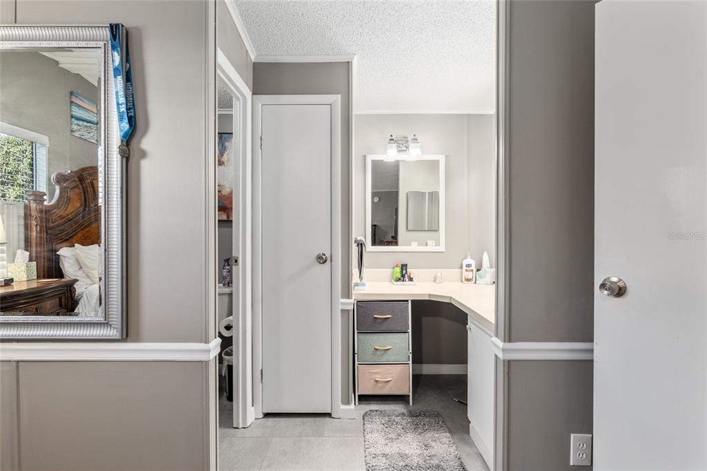 1727 Hilton Head Boulevard Lady Lake, FL 32159 - Photo 20 of 39 a view of cabinets and a bathroom with a mirror