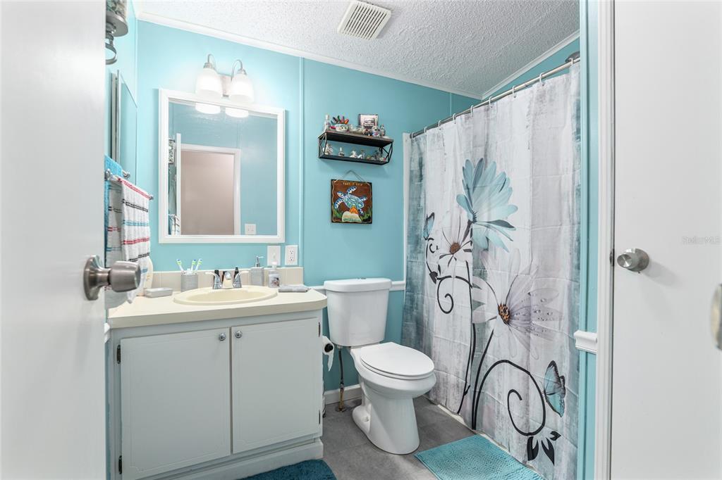 1727 Hilton Head Boulevard Lady Lake, FL 32159 - Photo 23 of 39 a bathroom with a toilet sink and mirror