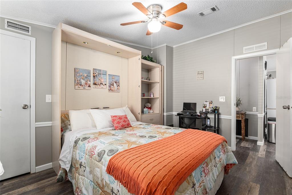 1727 Hilton Head Boulevard Lady Lake, FL 32159 - Photo 25 of 39 a bedroom with a bed and a chandelier