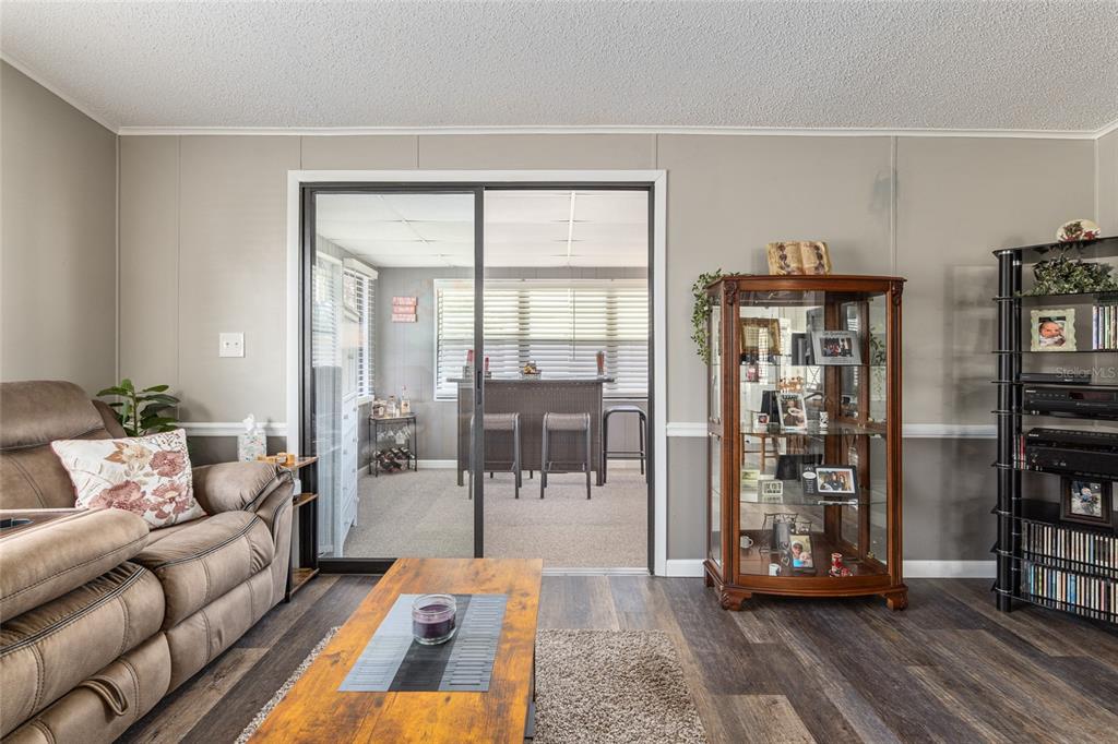 1727 Hilton Head Boulevard Lady Lake, FL 32159 - Photo 26 of 39 a living room with furniture and a book shelf
