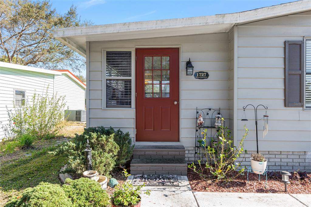 1727 Hilton Head Boulevard Lady Lake, FL 32159 - Photo 30 of 39 a front view of a house having yard