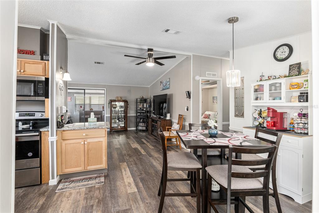 1727 Hilton Head Boulevard Lady Lake, FL 32159 - Photo 3 of 39 a view of a dining area with furniture window and wooden floor