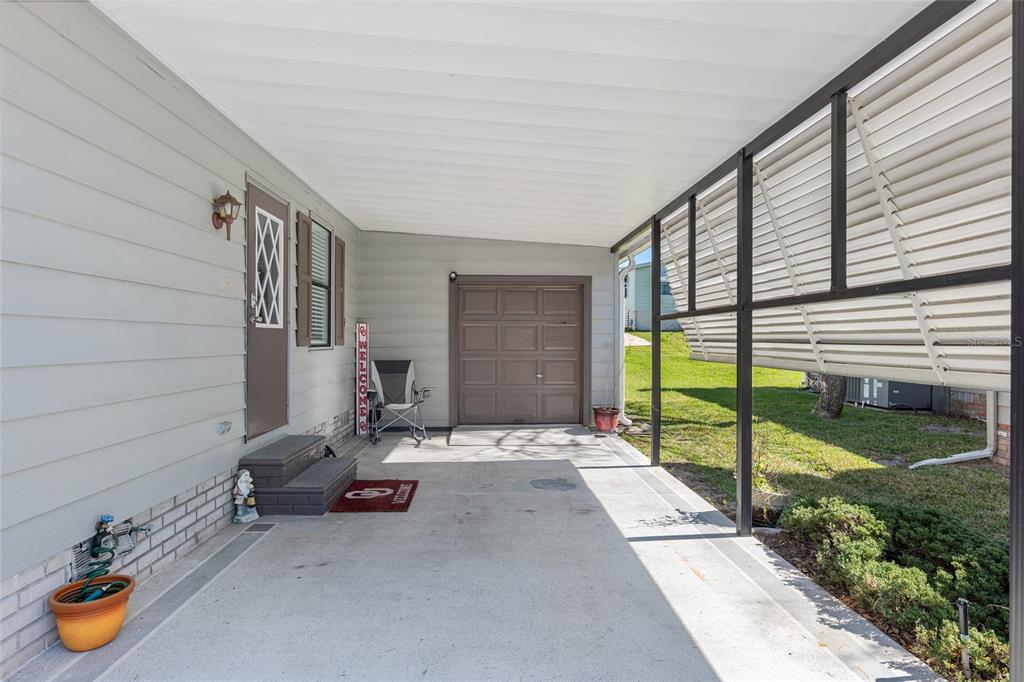 1727 Hilton Head Boulevard Lady Lake, FL 32159 - Photo 34 of 39 a view of a patio with table and chairs and potted plants