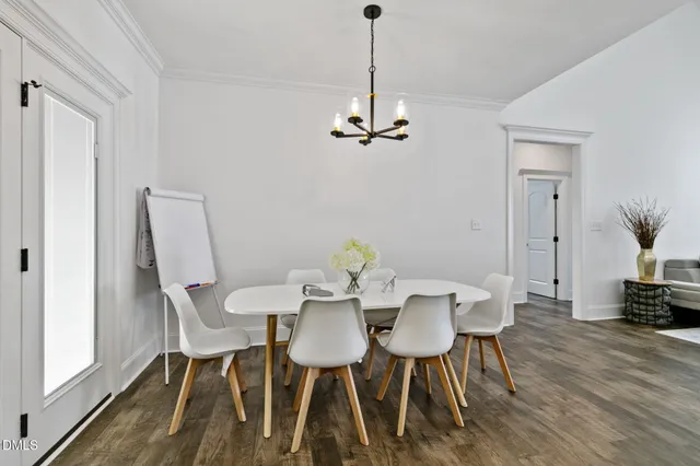 a view of a dining room with furniture wooden floor and a chandelier