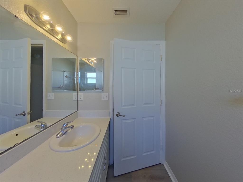 Undisclosed Address Davenport, FL 33837 - Photo 15 of 17 a bathroom with a sink and mirror with bathtub