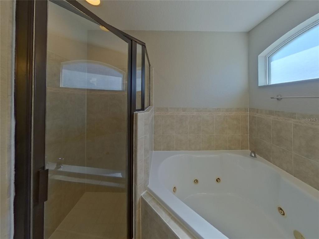 Undisclosed Address Davenport, FL 33837 - Photo 10 of 17 a bathroom with a bathtub