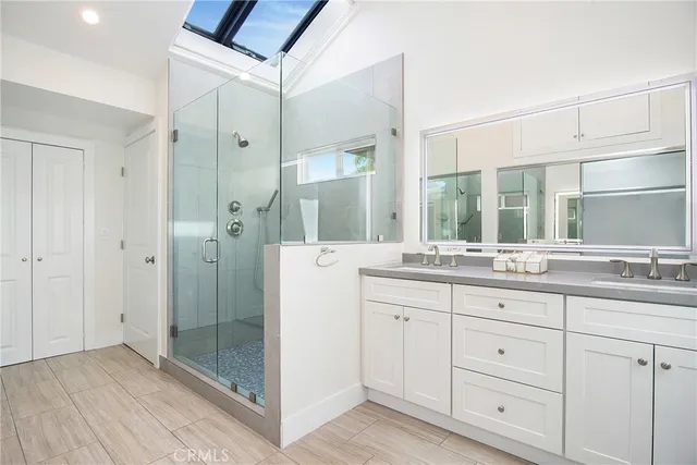 a bathroom with a shower sink and mirror