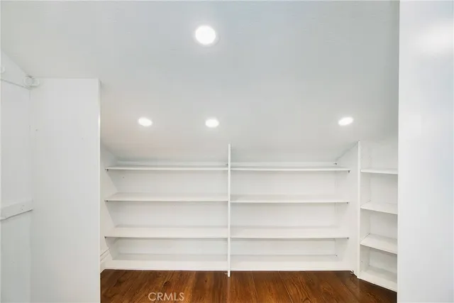 a view of a room with shelves on the wall