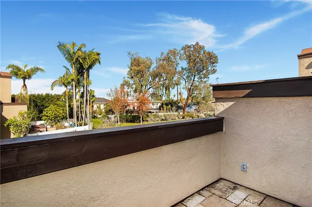 a view of a balcony with flower plants