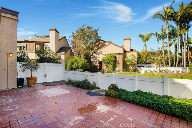 a front view of a house with a yard and potted plants