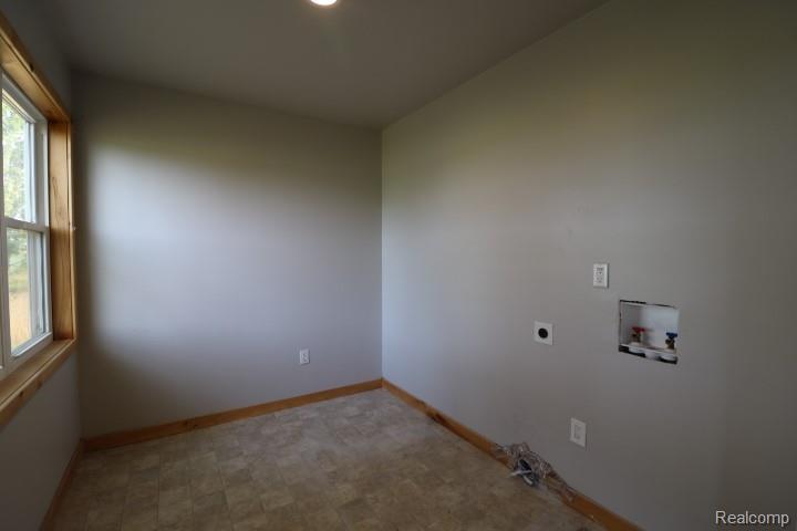 6577 East Deckerville Road Deford, MI 48729 - Photo 13 of 23 Recessed ceiling lighting, wood-trimmed window, and neutral wall tones