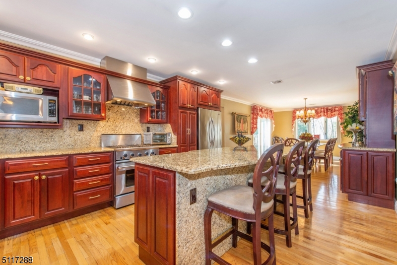 5 Spring Lane Warren, NJ 07059 - Photo 12 of 31 a kitchen with stainless steel appliances granite countertop a table chairs sink and cabinets