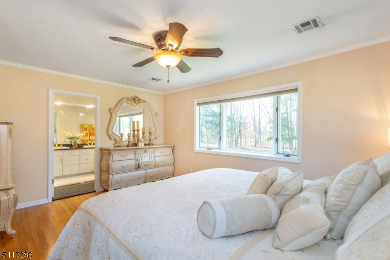 5 Spring Lane Warren, NJ 07059 - Photo 19 of 31 a bedroom with a large bed and a chandelier