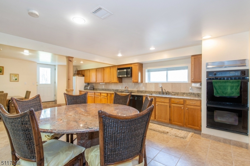 5 Spring Lane Warren, NJ 07059 - Photo 23 of 31 a dining room with furniture a window and kitchen view