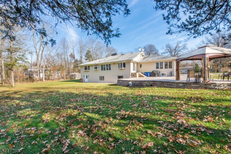 5 Spring Lane Warren, NJ 07059 - Photo 29 of 31 a front view of a house with a garden and trees