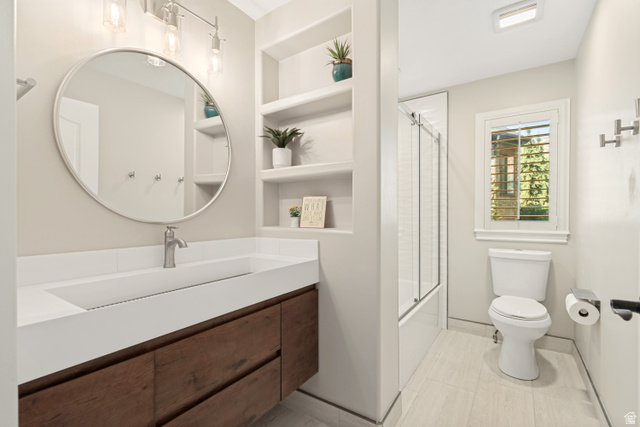 1567 Ridgeview Circle Farmington, UT 84025 - Photo 28 of 55 Modern primary bathroom featuring a circular framed mirror, floating wood-finish vanity with rectangular vessel sink, white quartz countertop, chrome faucet, built-in shelving with decorative accents, walk-in shower with glass enclosure, and light wood-fi