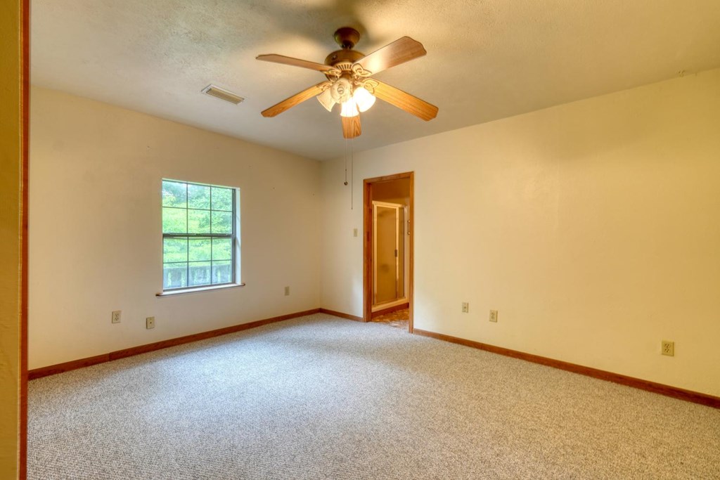1066 Ridge Road Hiawassee, GA 30546 - Photo 27 of 51 an empty room with windows and fan