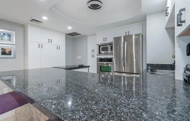 a view of kitchen with refrigerator stove microwave and stove