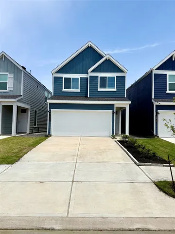 a front view of a house with a garden and yard