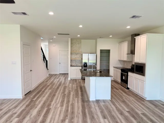a large kitchen with cabinets
