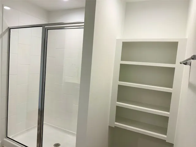 a view of walk in closet with empty racks