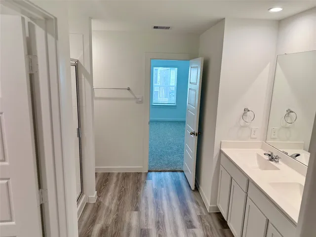 a bathroom with a sink a mirror and a shower