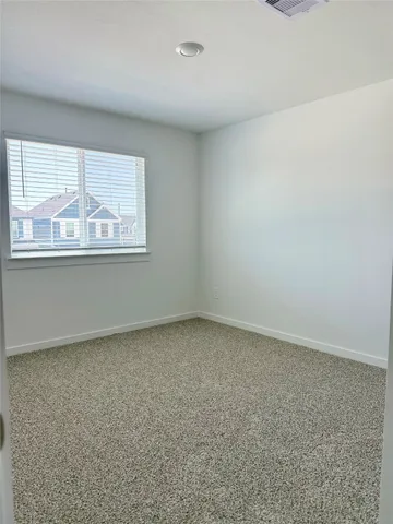 an empty room with closet and cabinet
