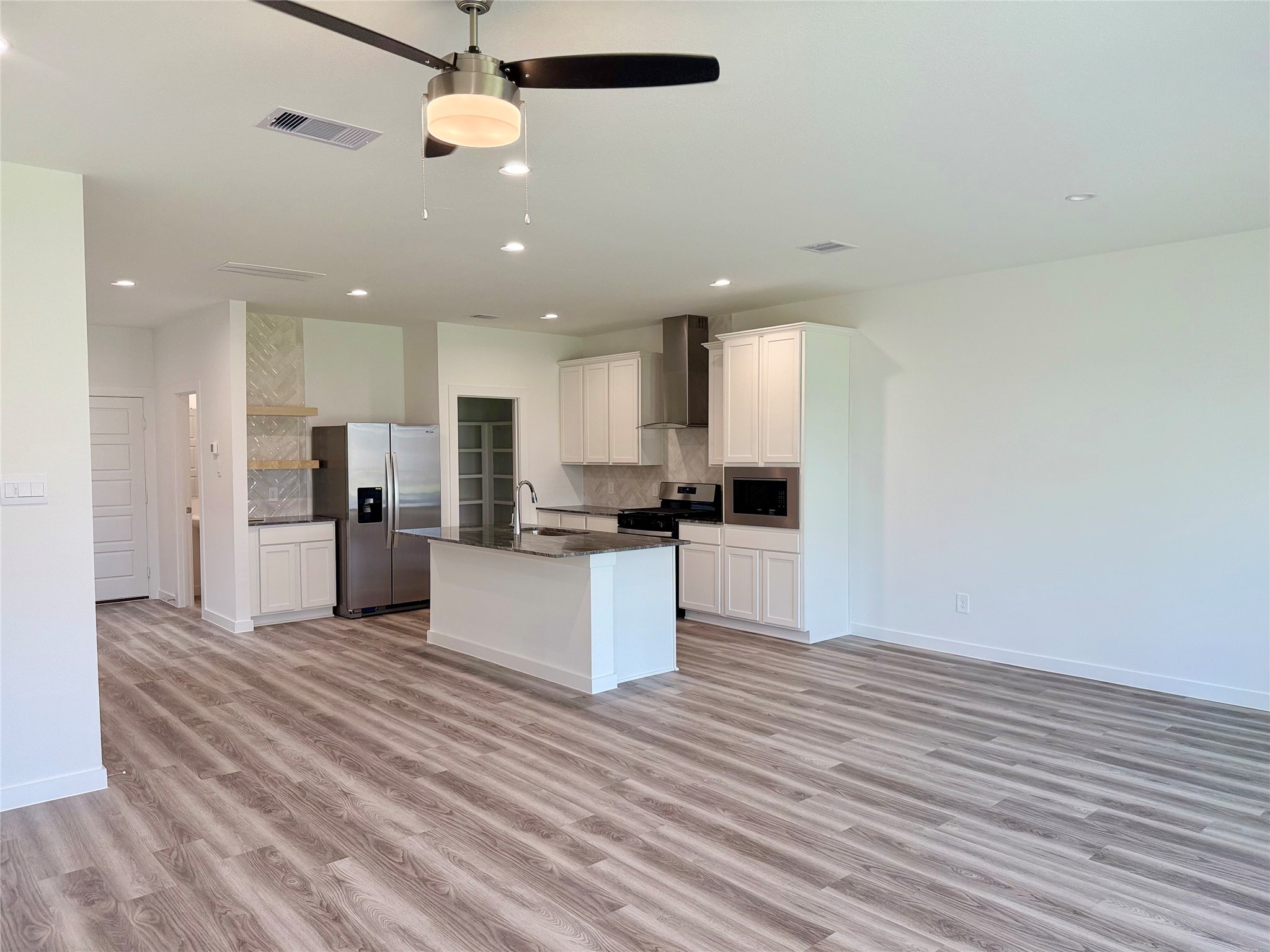 2911 Needham Gdn Lane Houston, TX 77051 - Photo 7 of 50 a view of kitchen with kitchen island wooden floor center island and stainless steel appliances