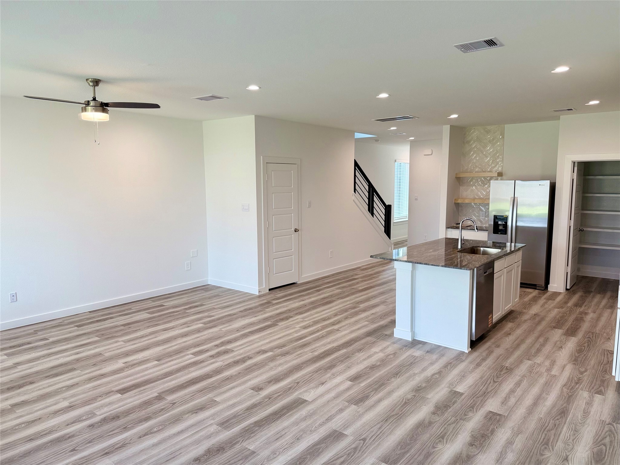 2911 Needham Gdn Lane Houston, TX 77051 - Photo 8 of 50 a kitchen with stainless steel appliances kitchen island granite countertop a refrigerator and a stove