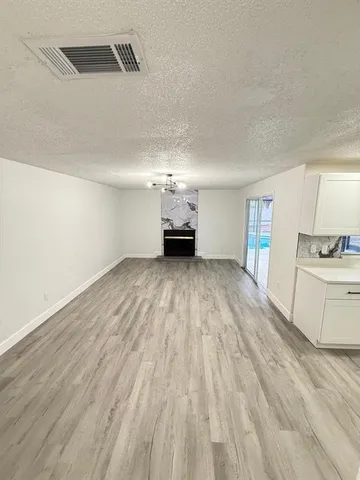 a view of a kitchen with wooden floor