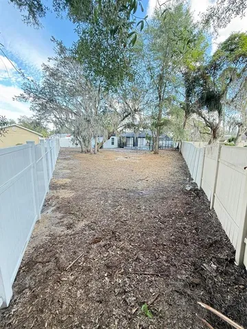 a view of a pathway with a wrought fence