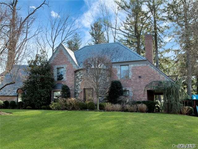 134 Old Mill Road Manhasset, NY 11030 - Photo 1 of 1 a front view of a house with a garden
