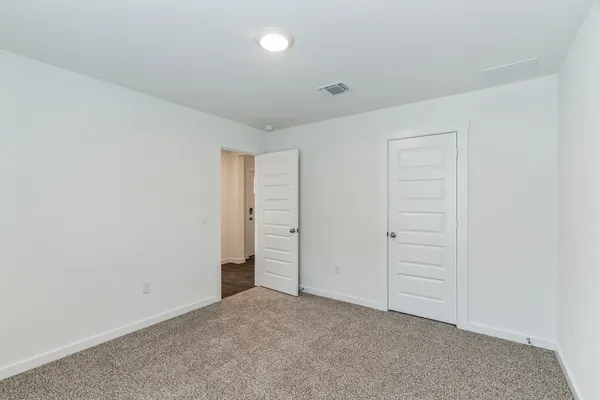 an empty room with closet area