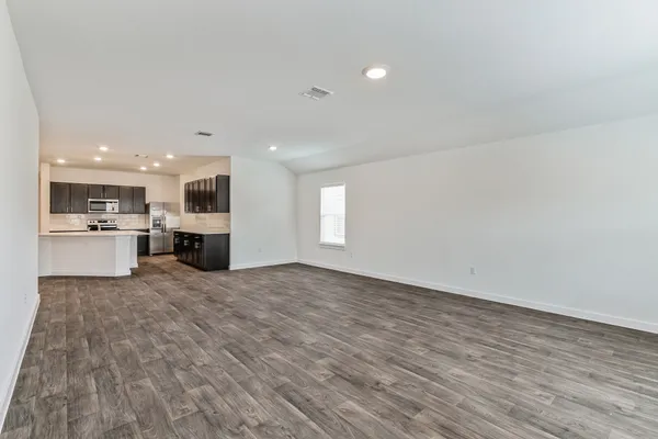 a view of kitchen with wooden floor and windows