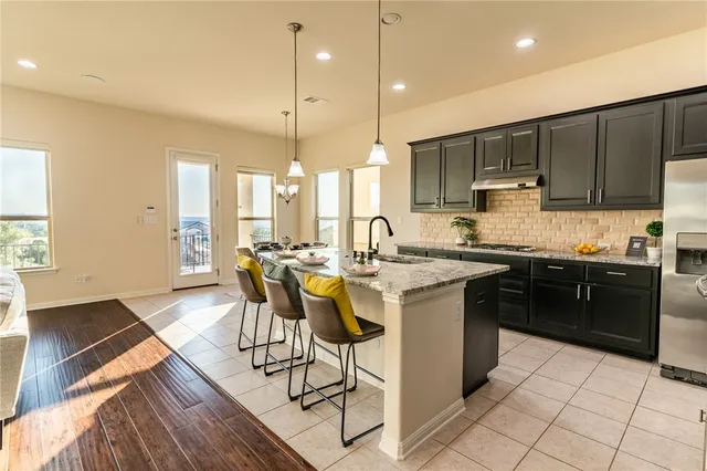 a kitchen with a sink a counter top space appliances and cabinets